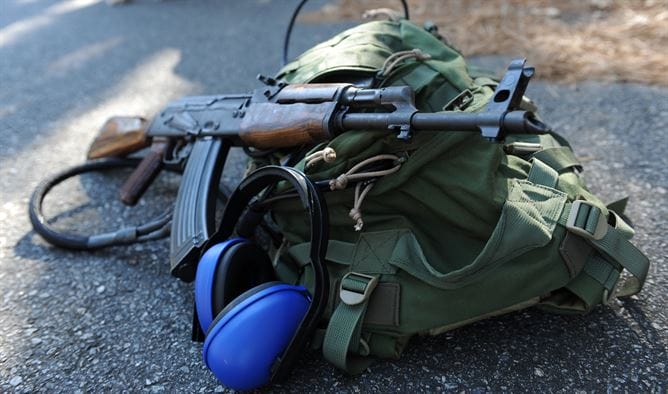 image of a range bag with a rifle and ear muff
