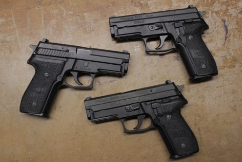 a picture of three sig p229s