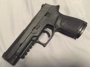 a picture of a SIG P320 with a full slide and a compact frame