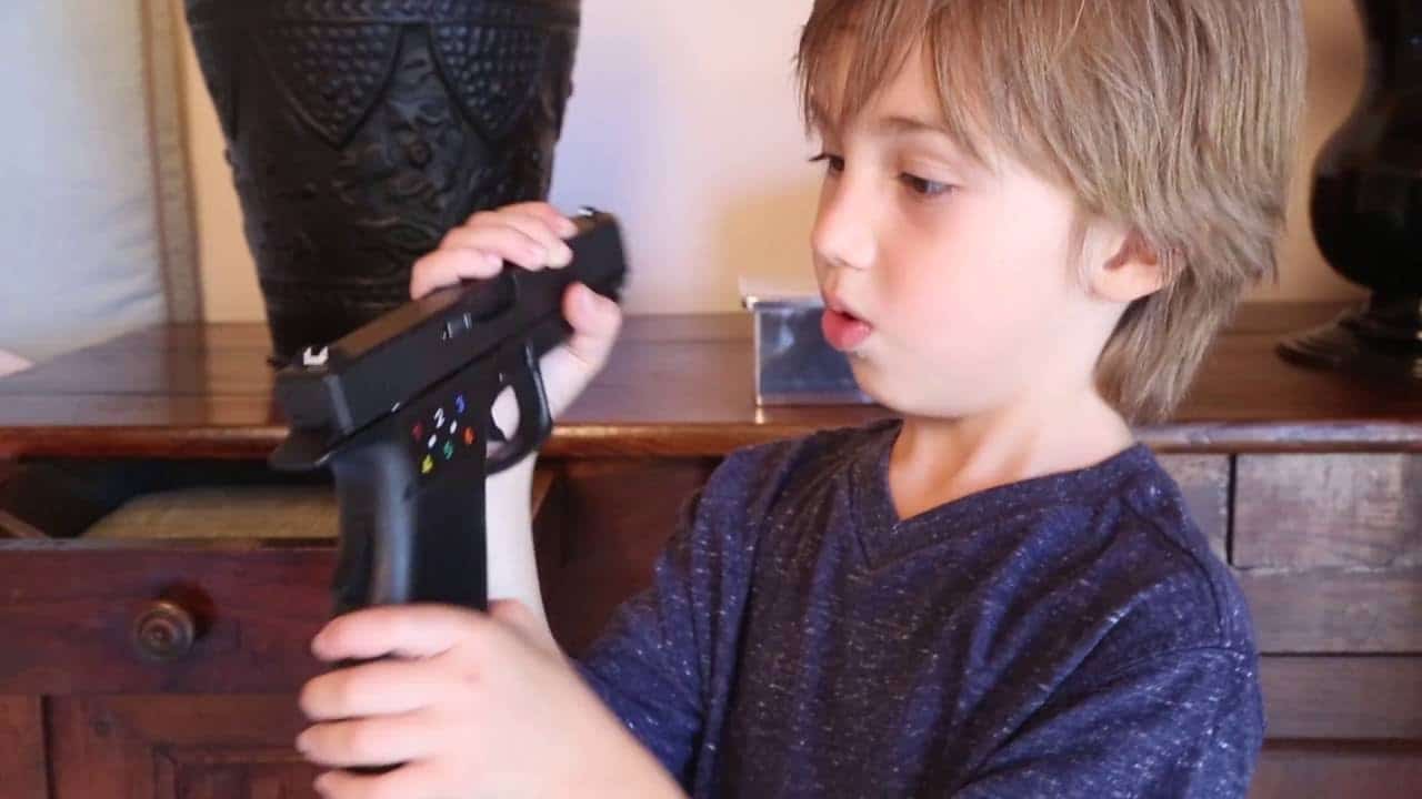 a kid curios to a gun