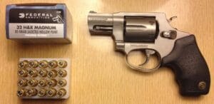 a picture of .32 H&R Magnum cartridges with a Taurus revolver