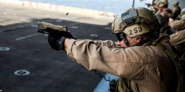 a picture of a US Marine shooting a 1911