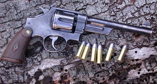 A picture of a S&W Triple Lock with 44 Special cartridges