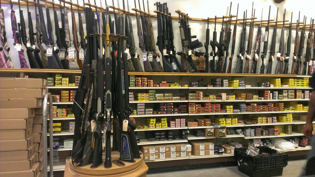 image of rifles and ammunition in a gun store