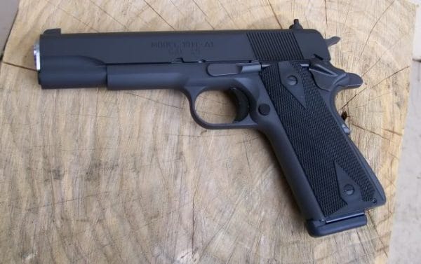 The Springfield Armory Mil-Spec 1911 semi automatic pistol with original short trigger and GI style thumb and grip