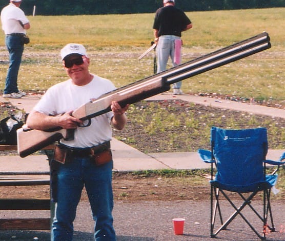 Man holding an extremely big rifle