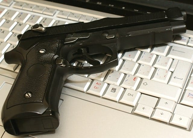 where to buy guns online - image of gun on a laptop keyboard