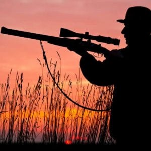Image of a man holding rifle silhouette