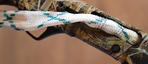 picture of cleaning a camo rifle with a bore snake