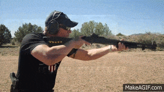 a man shooting a shotgun with proper stance