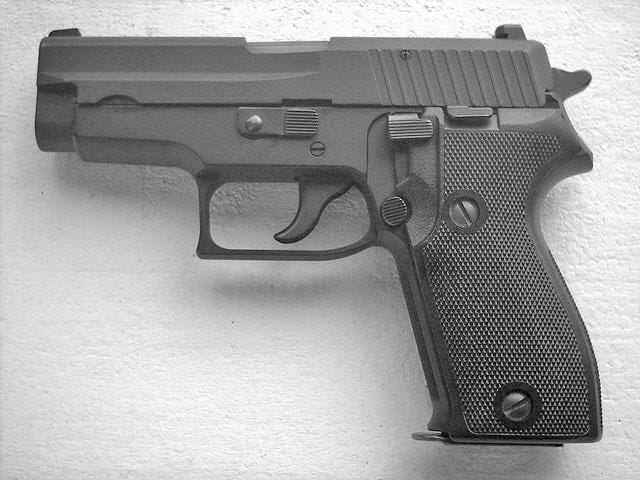 The 10mm Sig Sauer P220 semi automatic pistol's SigLite signature night sights makes for easy target acquisition