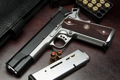 The 10mm Wilson Combat Classic semi automatic pistol has a low-mounted adjustable rear sight and bullet proof one-piece magazine