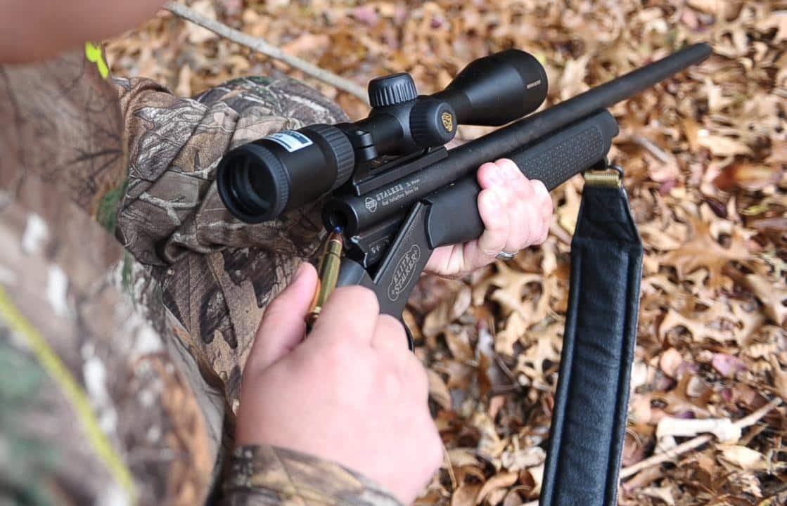 Man shooting a deer rifle with scope