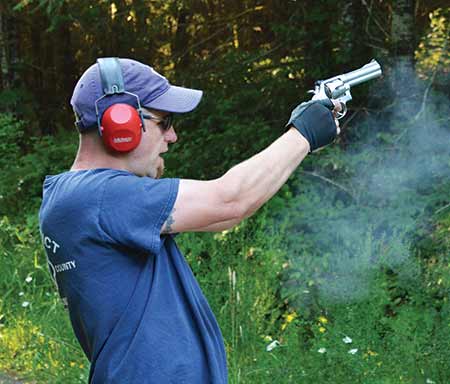 picture of a guy shooting a magnum revolver
