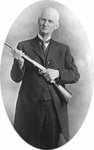 John Moses Browning Portrait holding a rifle 