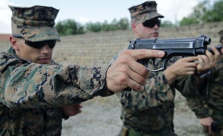 a picture of The Beretta M92FS held by a US Marine