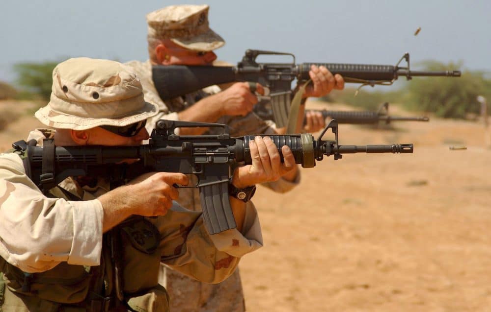 men firing an ar15 rifle