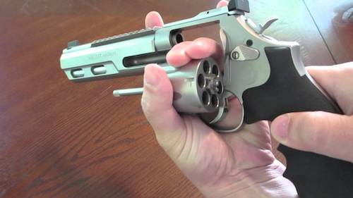 Flicking the cylinder of a .357 magnum revolver for reloading