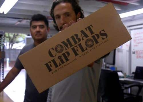 Matt Griffin, the Combat Flip-Flops founder. holding up a box of flip flops