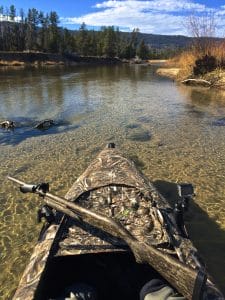 duck hunting kayak and rifle
