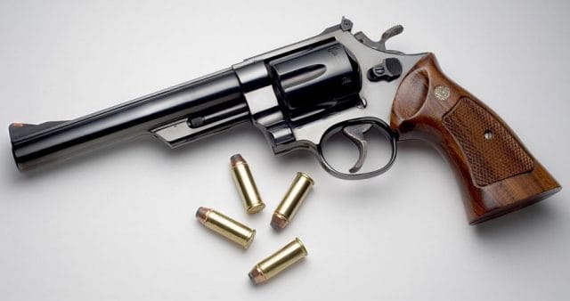 A picture of a S&W Model 29 with 44 Magnum cartridges