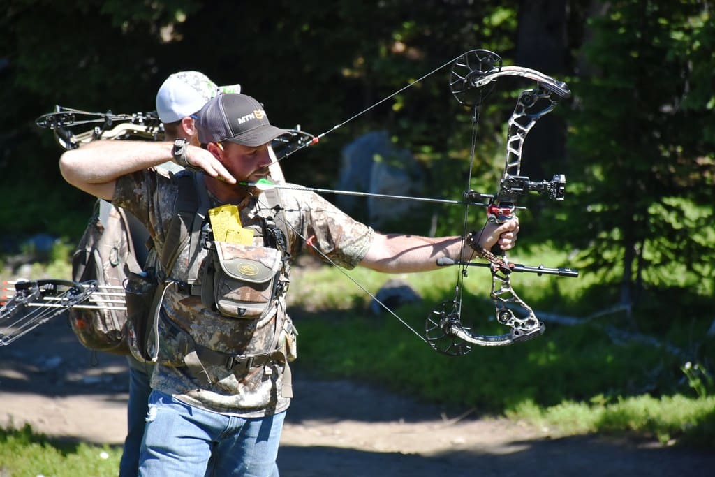 image of a man using his compound bow for hunting