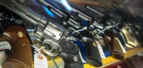 revolvers on a gun store shelf